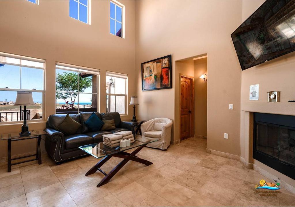 a living room with a couch and a fireplace at Come, Experience, Collect memories 24-1 in San Felipe