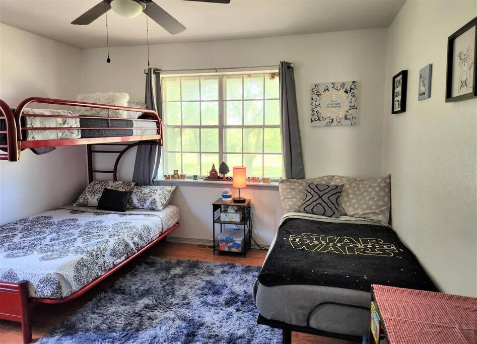 a bedroom with a bunk bed and a couch at Blue Door Farmhouse in Meeker