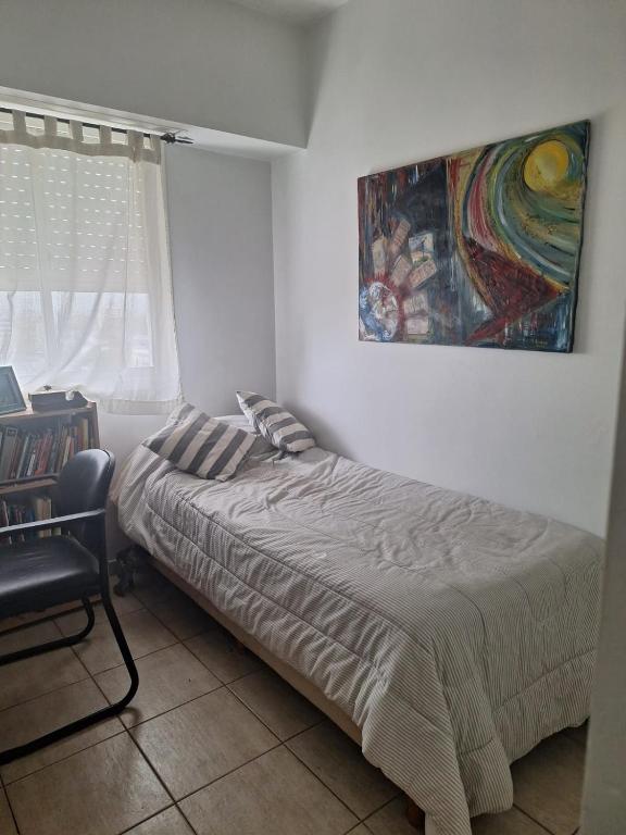 1 dormitorio con 1 cama y una pintura en la pared en Habitación BA en Florida
