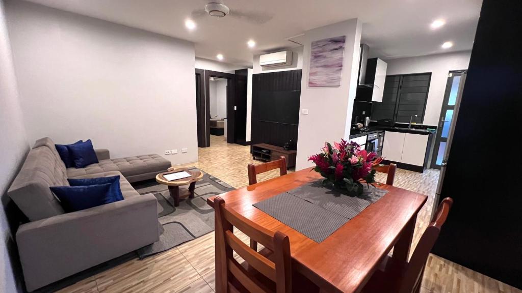 a living room with a table and a couch at GreyStone Apartments in Nadi