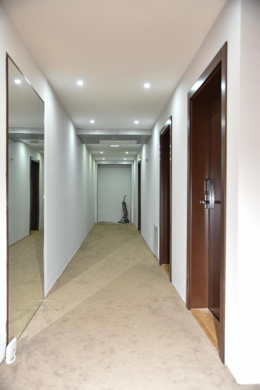 an empty hallway with a cat sitting in the distance at Apartmani COLOSSEUM in Bratunac