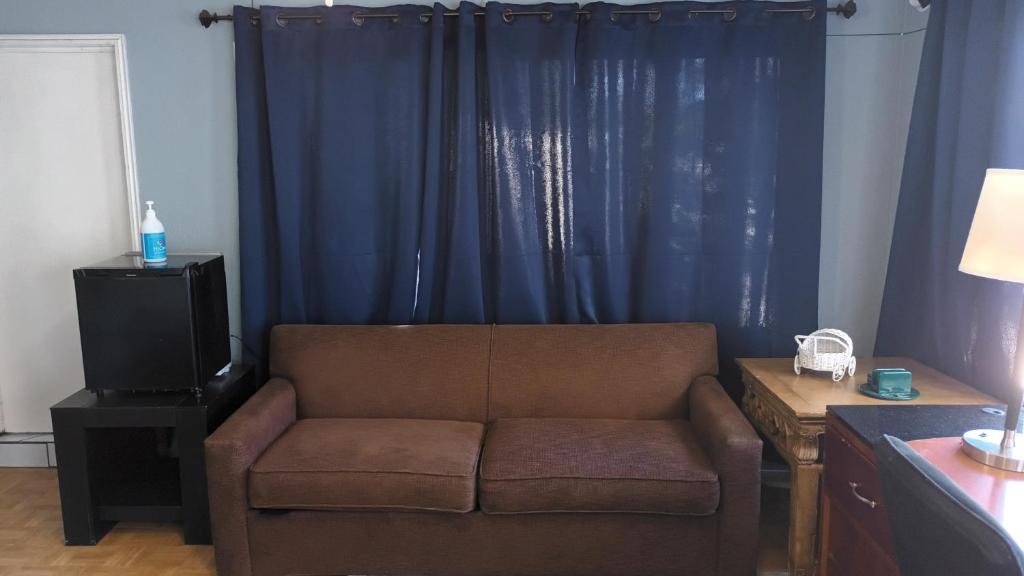 a living room with a couch and a blue curtain at Elegant Suite in Tijuana