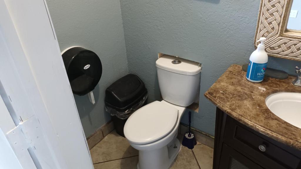 a bathroom with a toilet and a sink at Presidential Suite in Tijuana