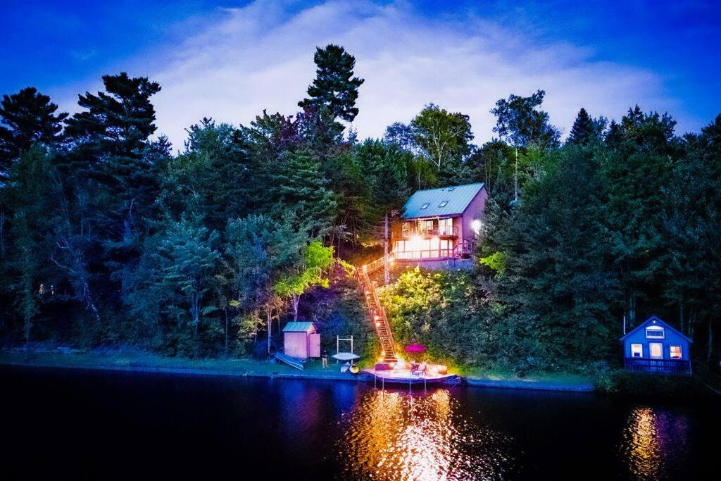 a house on the shore of a lake at night at Stairway To Heaven-VT Lakefront! in Eden