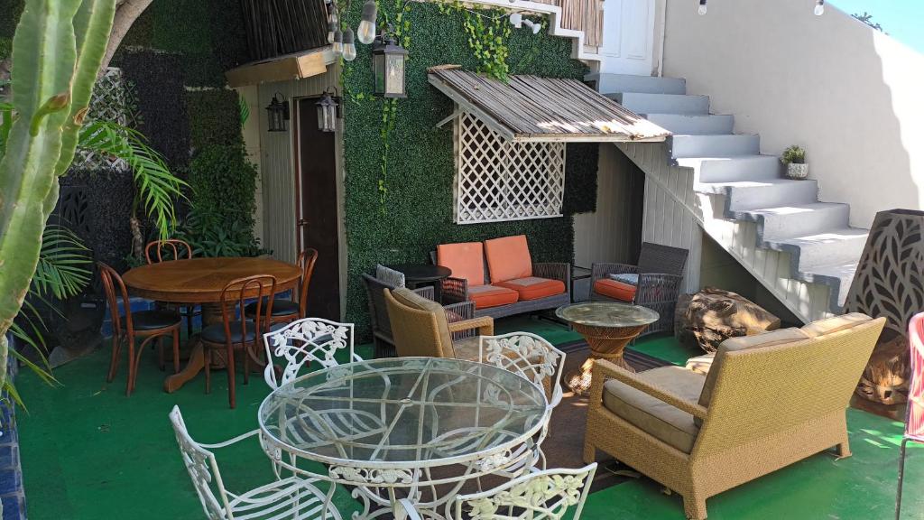 a patio with a table and chairs and a table and stairs at Trendy green Cabin in Tijuana