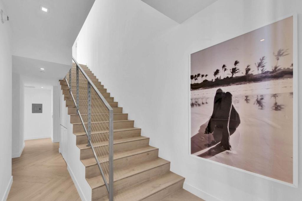 a staircase in a white room with a picture on the wall at W South Beach in Miami Beach