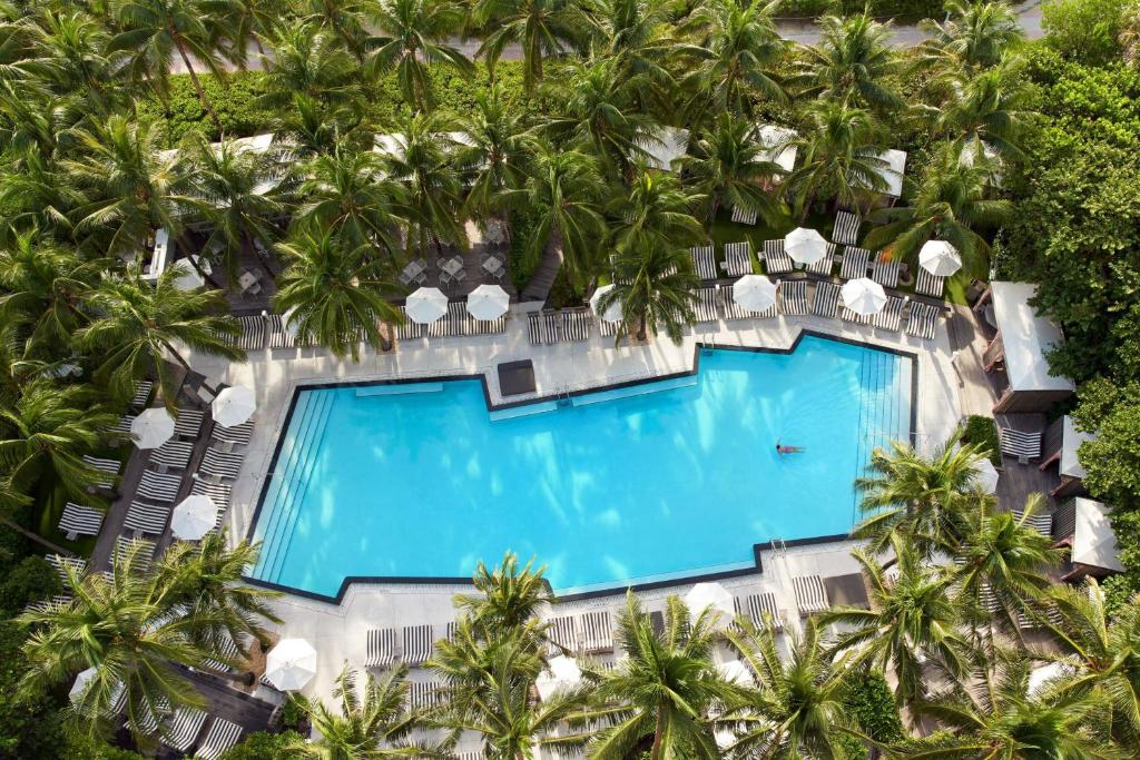 an aerial view of a resort pool with palm trees at W South Beach in Miami Beach