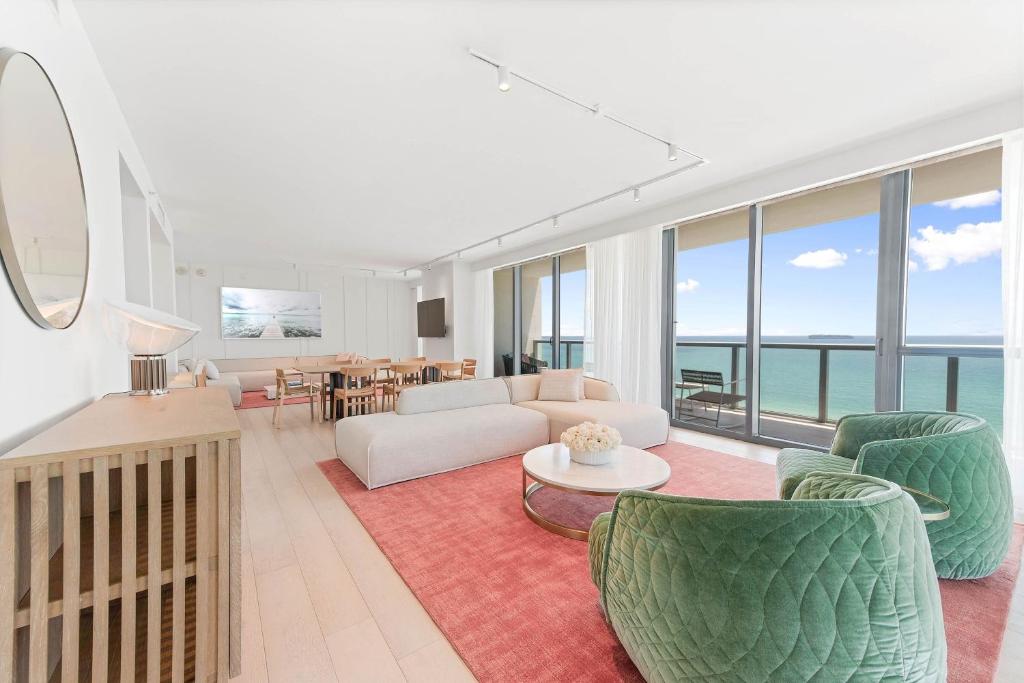 a living room with a couch and chairs at W South Beach in Miami Beach