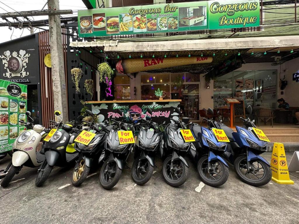 a row of motorcycles parked in front of a store at Gorgeous Boutique Room in Patong Beach