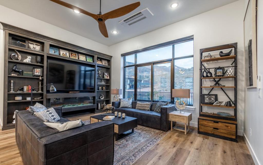 a living room with a couch and a tv at Paradise Retreat at Copper Rock! in Hurricane