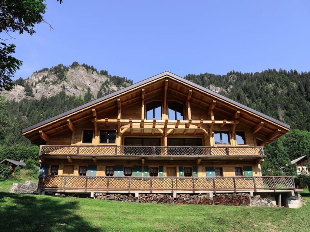 a large wooden house with a mountain in the background at Chalet Châtel, 4 pièces, 9 personnes - FR-1-676-44 in Châtel