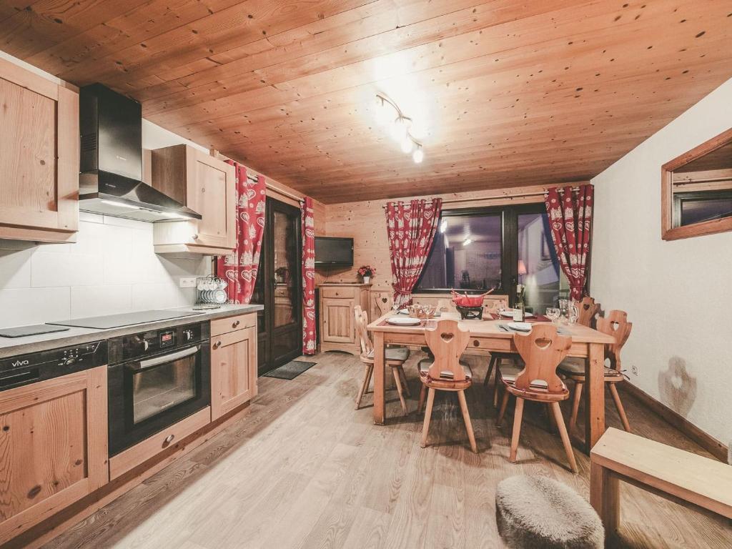une cuisine avec une table et des chaises dans une pièce dans l'établissement Charmant 3 pièces pour 7 pers. avec balcon, proche centre et télécabine, WiFi inclus - FR-1-676-132, à Châtel
