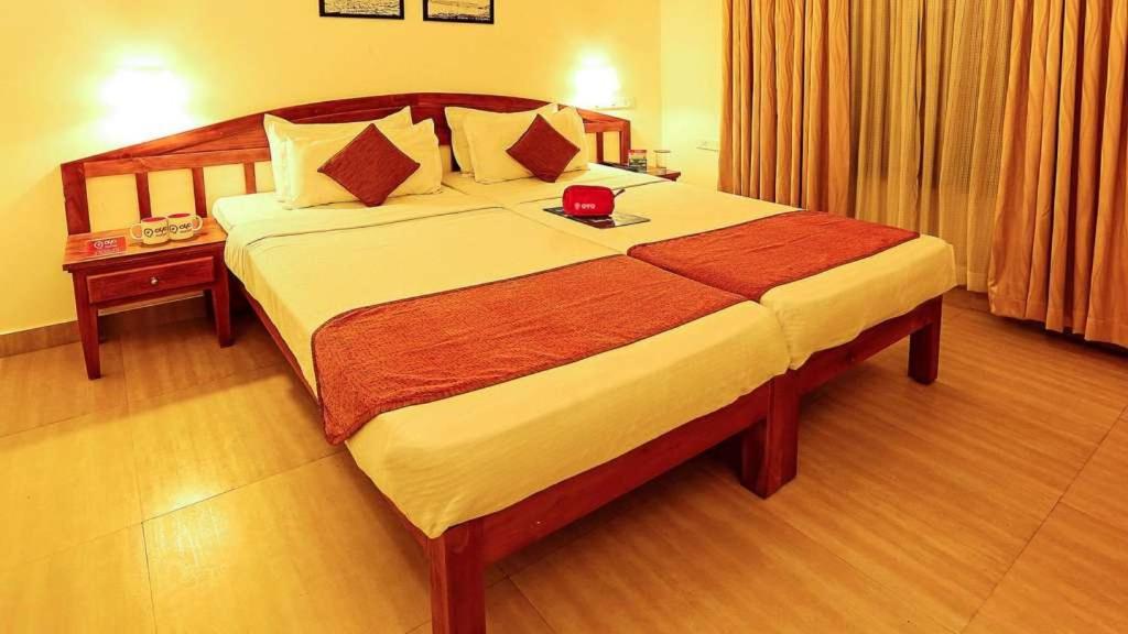 a bedroom with a large bed in a hotel room at Pepper Route, Fort Kochi in Fort Kochi