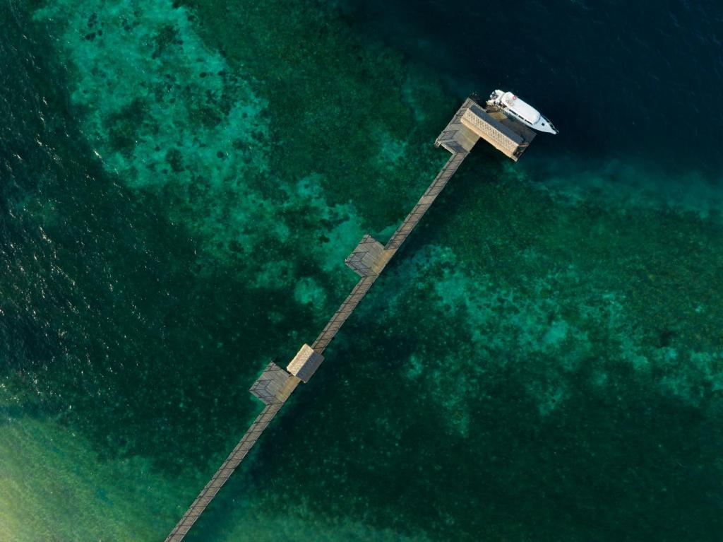 an aerial view of a dock in the water at Sudamala Resort, Seraya, Flores in Labuan Bajo