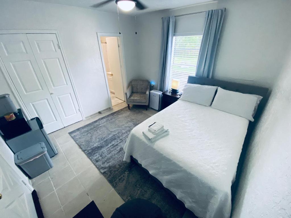 a bedroom with a white bed and a window at Holistic Gem w/1Gig Wi-Fi & free parking in Houston
