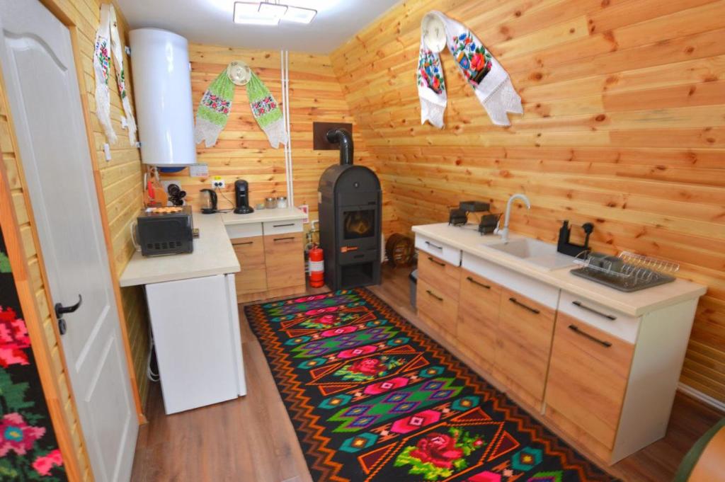a kitchen with a stove and a sink in a room at A frame Sima in Breb