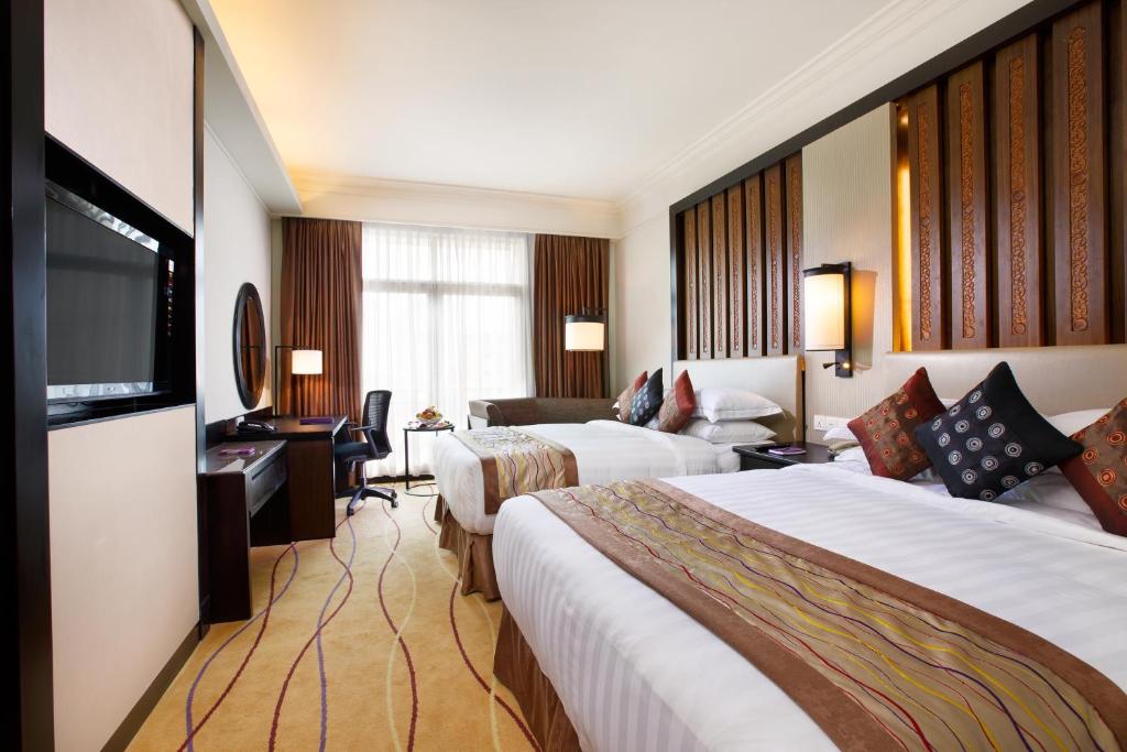 A bed or beds in a room at PARKROYAL Yangon