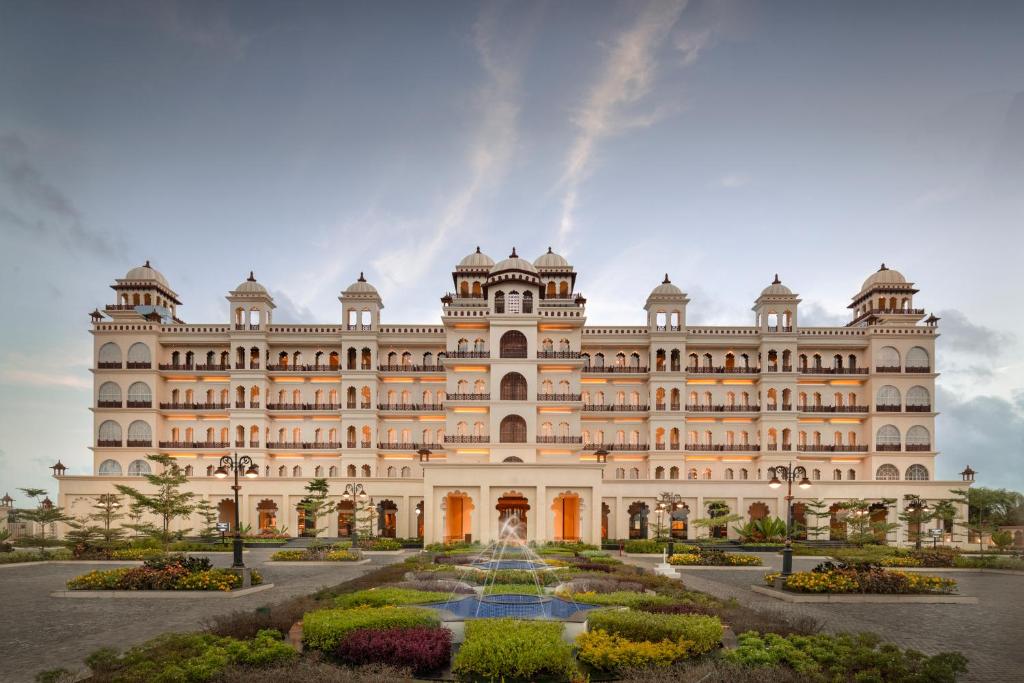 a building with a garden in front of it at Uday Palace Navsari, a member of Radisson Individuals in Navsāri
