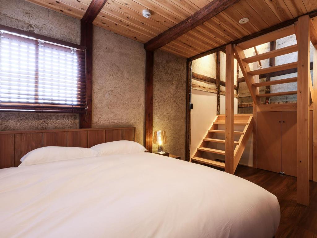 Postel nebo postele na pokoji v ubytování NIPPONIA 田原本 マルト醤油