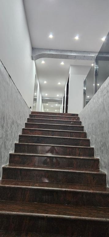 a set of stairs in a building with wooden steps at Apartmani COLOSSEUM in Bratunac