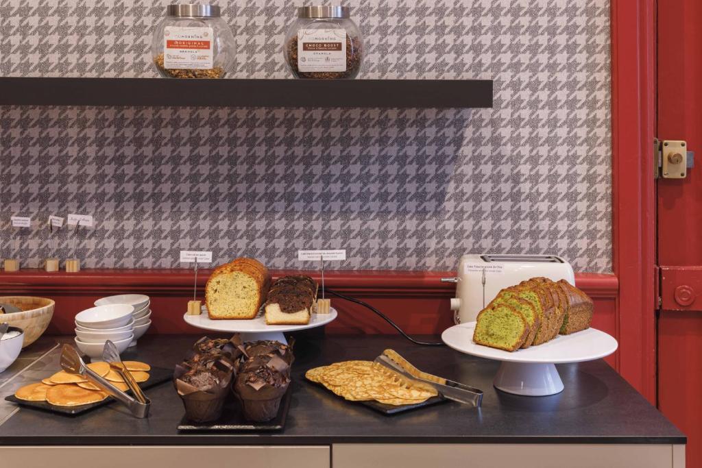 a counter with three plates of bread and pastries at Hôtel de Noailles in Lyon