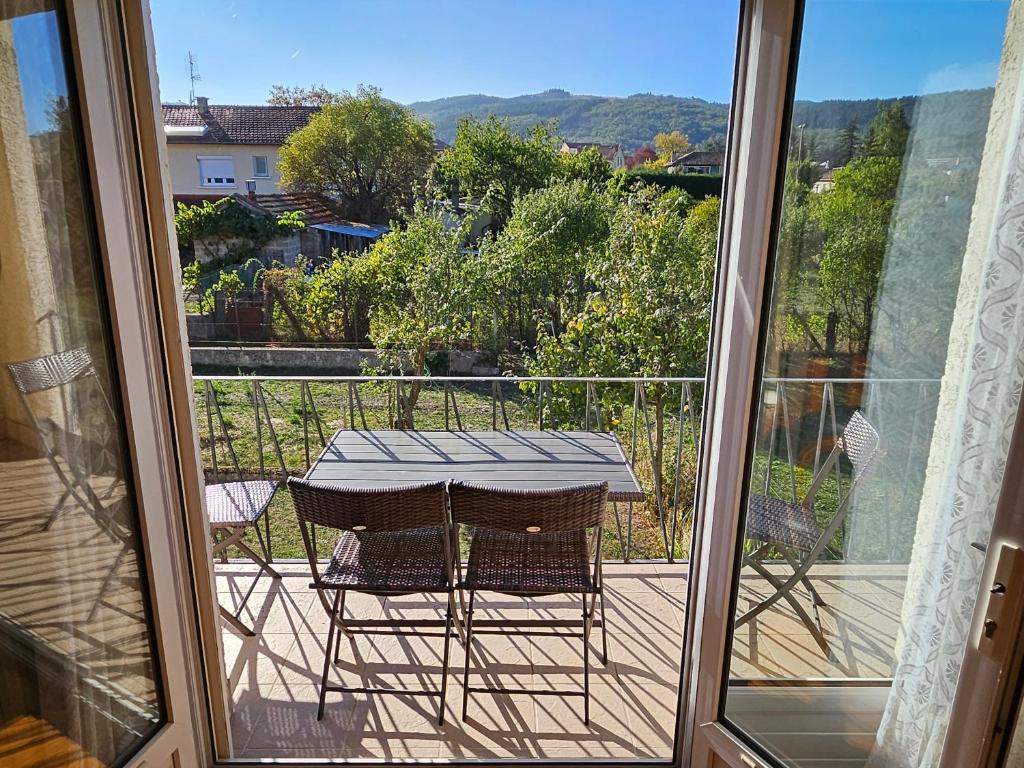 a table and two chairs on a balcony at La Bourzede F3 in Langeac