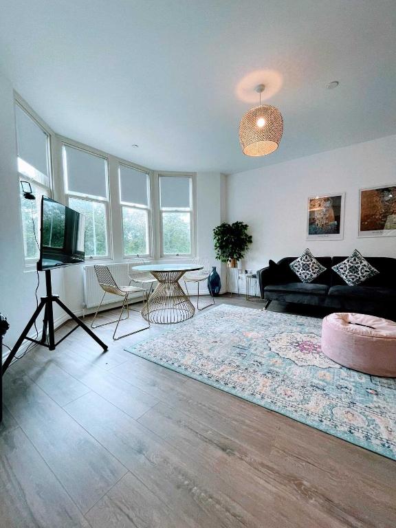 a living room with a couch and a table at Cardiff luxury apartment in Cardiff
