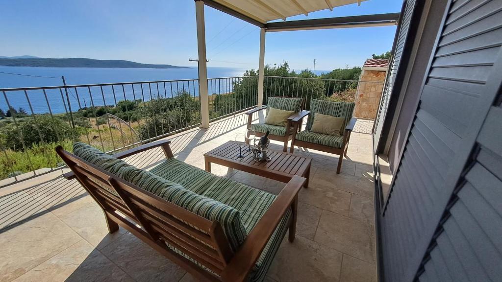 a patio with two chairs and a table on a balcony at Apartmani STJEPAN in Zavala