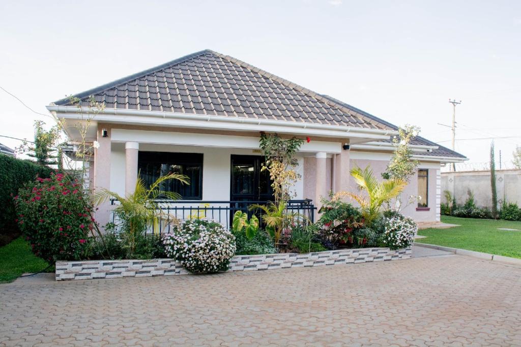 a small house with a fence and a brick driveway at Lux Suites Eldoret Luxury Villas in Eldoret