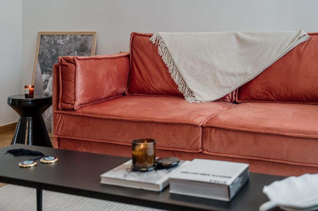 a brown couch with a coffee table in a living room at Bella in Athens