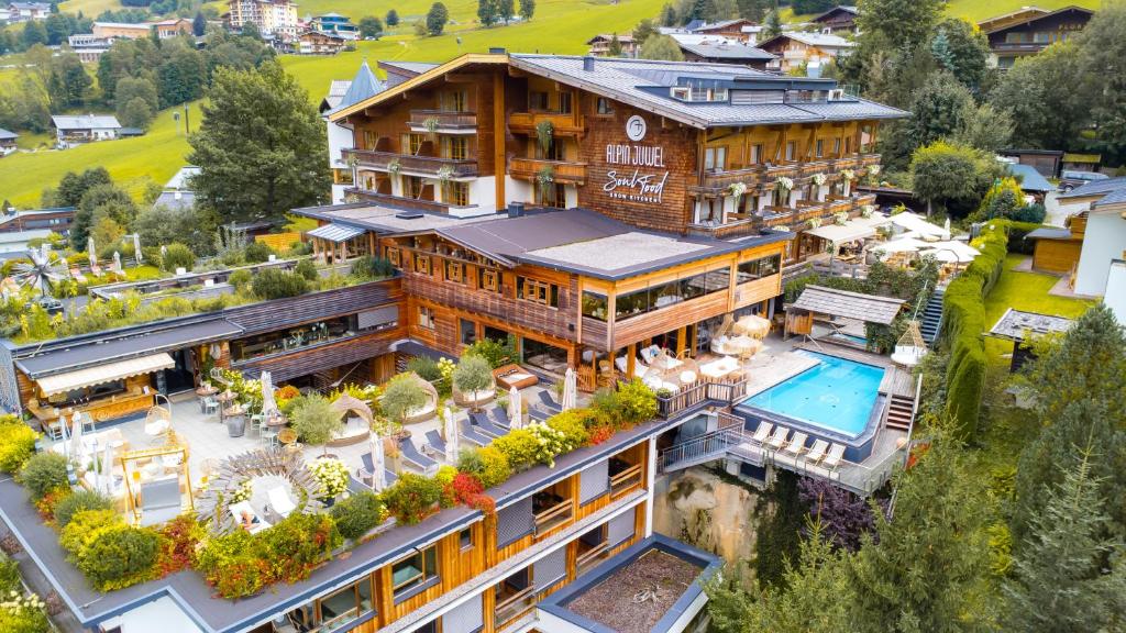 an aerial view of a mansion with a swimming pool at Alpin Juwel in Saalbach-Hinterglemm