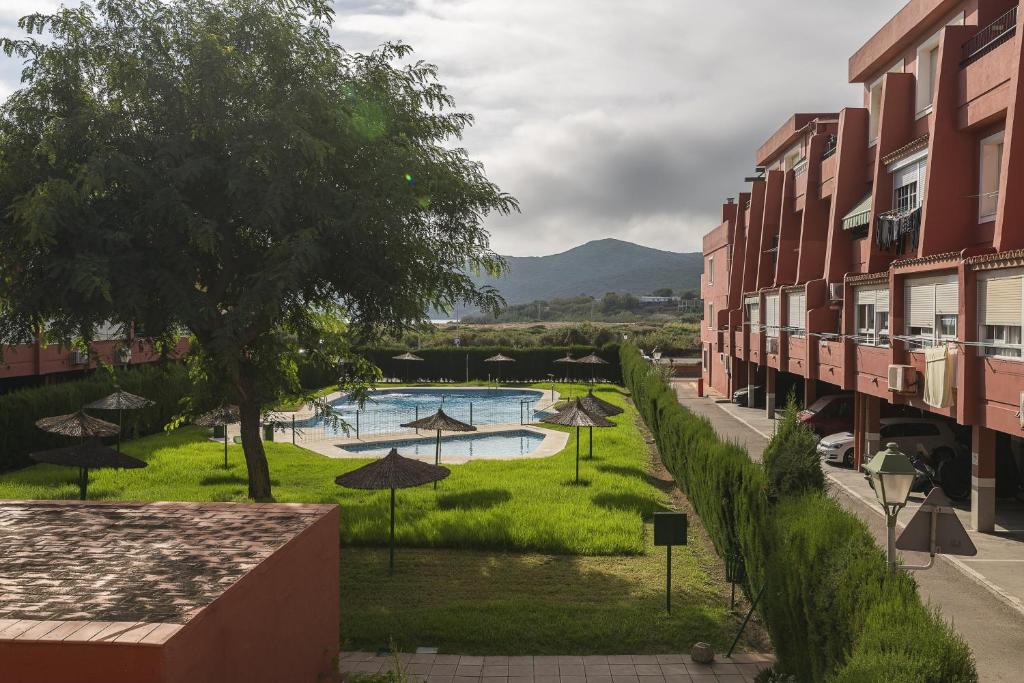 widok na basen z parasolami i budynkami w obiekcie Camarote de Algetares w mieście Algeciras