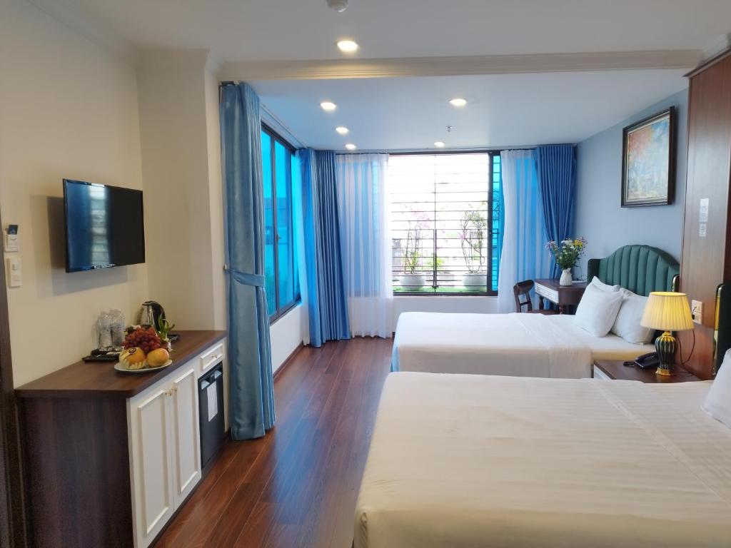 Postel nebo postele na pokoji v ubytování Hanoi Vacanza Premier Hotel