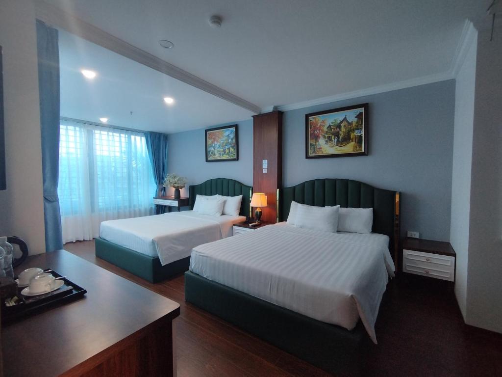 Postel nebo postele na pokoji v ubytování Hanoi Vacanza Premier Hotel