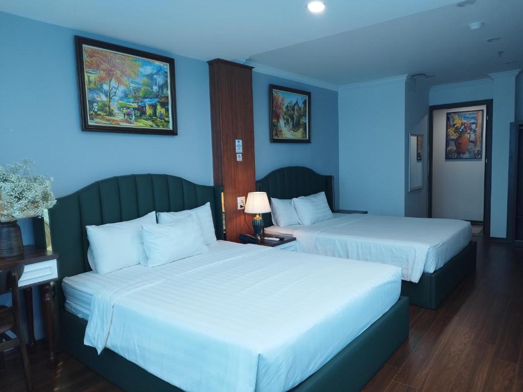 Postel nebo postele na pokoji v ubytování Hanoi Vacanza Premier Hotel