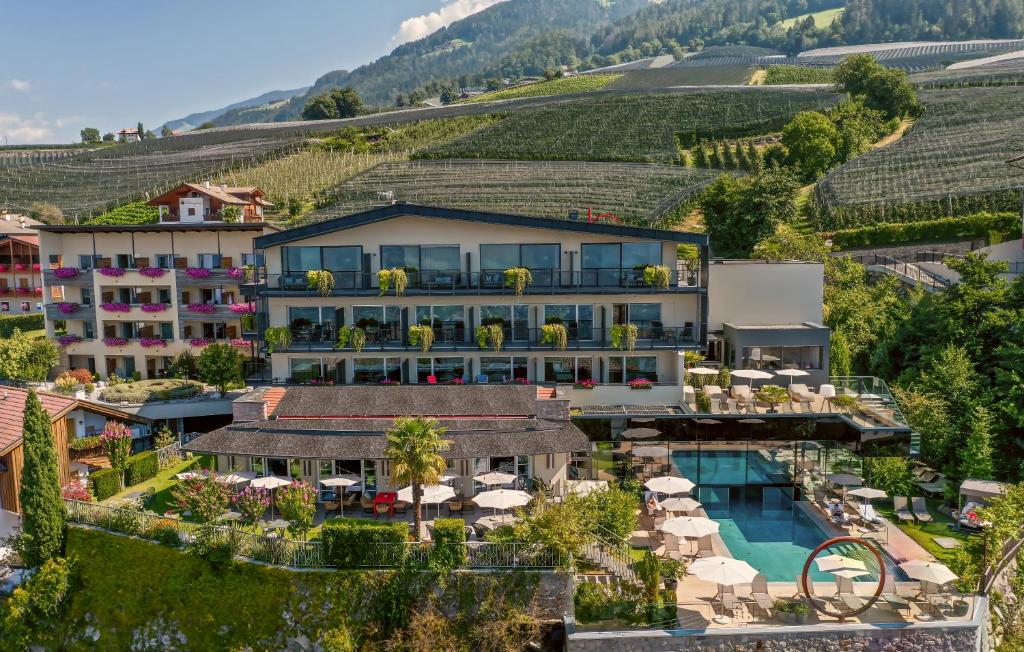 an aerial view of a hotel with a vineyard at Hilburger Hotel in Schenna