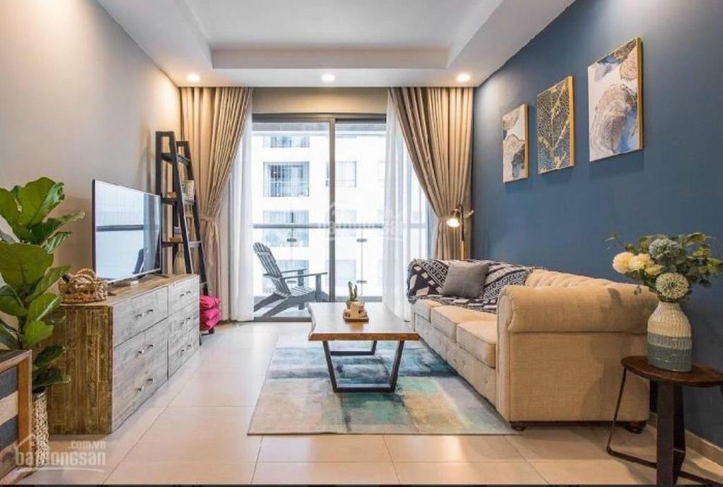a living room with a couch and a tv at 30% promotion for Gold view apartment in the center of District 4, Ho Chi Minh, Vietnam in Ho Chi Minh City