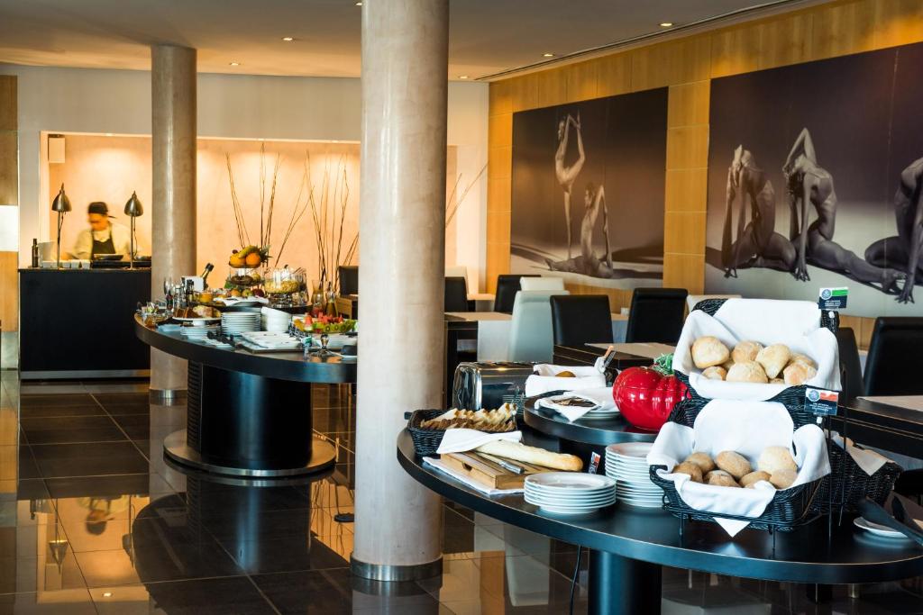 a hotel lobby with two tables with food on them at Vila Gale Collection Praia in Albufeira