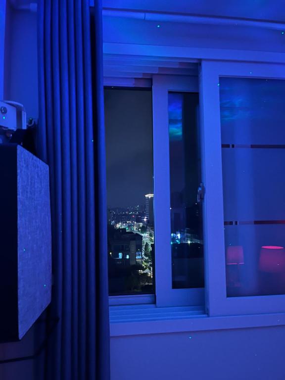 - une fenêtre avec vue sur la ville la nuit dans l'établissement Stunning Luxury Apartment, à Séoul