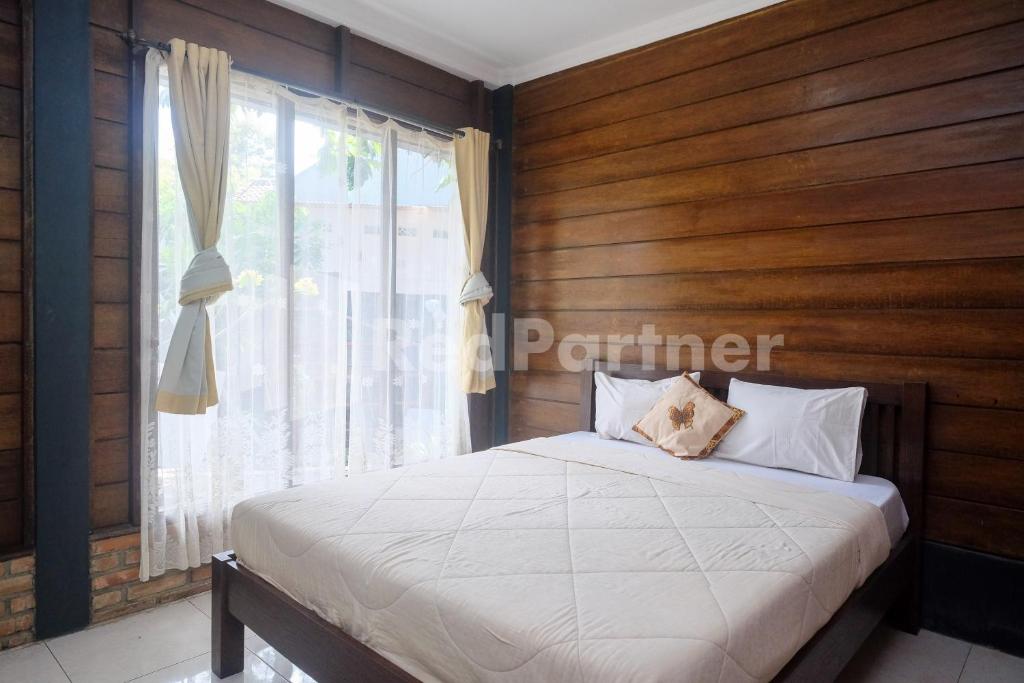 Postel nebo postele na pokoji v ubytování Kebon Krapyak Cottage Syariah Mitra RedDoorz near Stadion Maguwoharjo