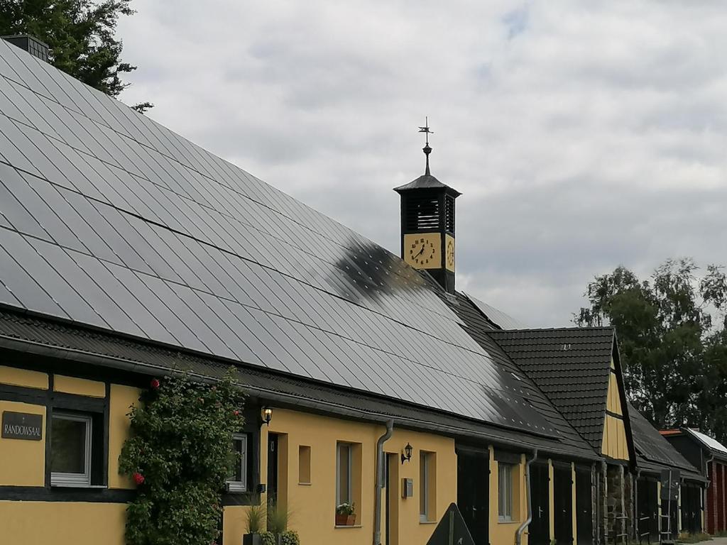 a roof of a building with a clock tower at Randowpark in Eggesin