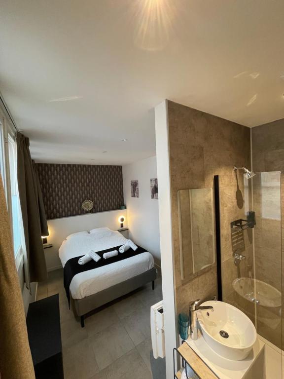 a hotel room with a bed and a bathroom at D 28 in Bruges