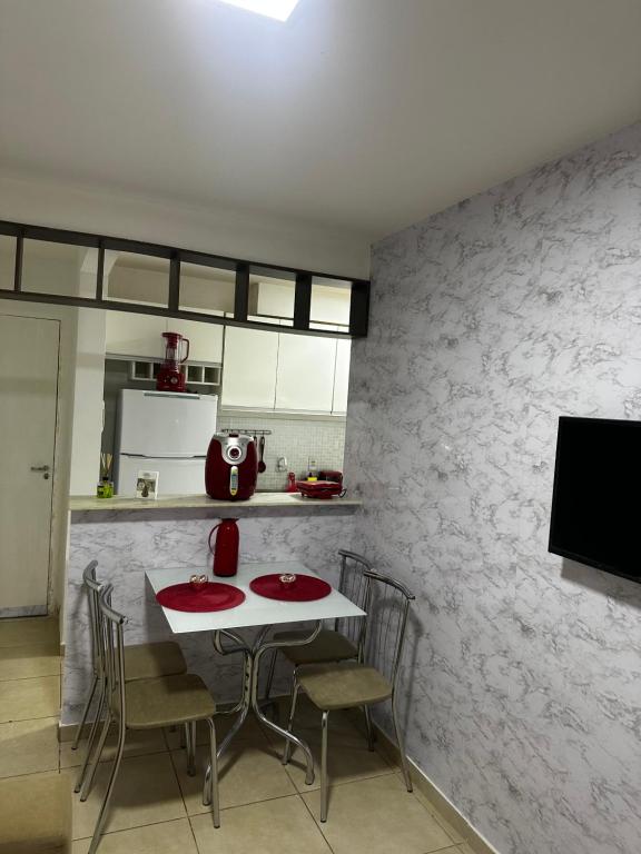 a kitchen with a table and chairs in a room at Apt da Leily in São Luís