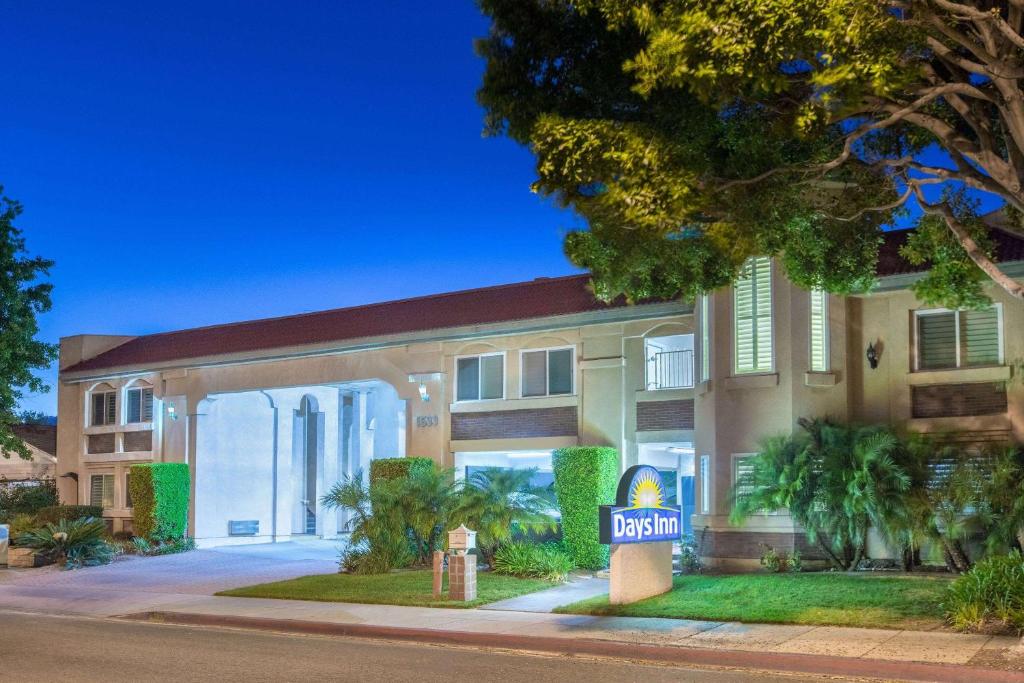 a hotel with a sign in front of it at Days Inn by Wyndham Near City Of Hope in Duarte