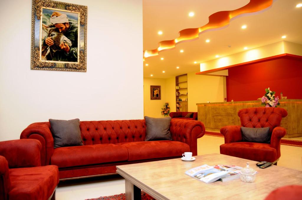 a living room with a couch and a table at Tehran Boutique Hotel in Doğubayazıt