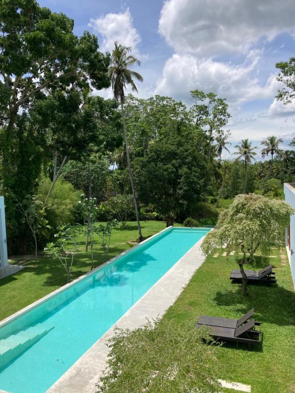 uma imagem de uma piscina numa villa em UYANA Boutique Hotel and Retreat ADULTS ONLY em Ahangama