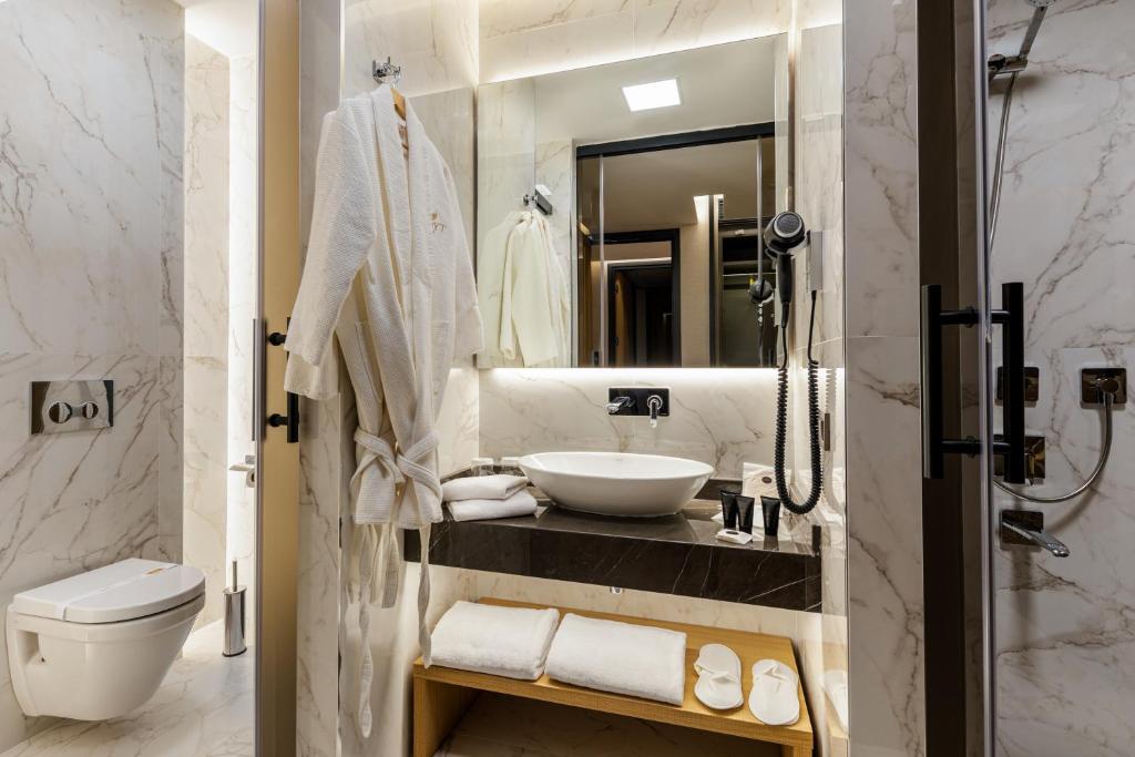 a bathroom with a sink and a toilet and a mirror at Broyt Hotel in Istanbul