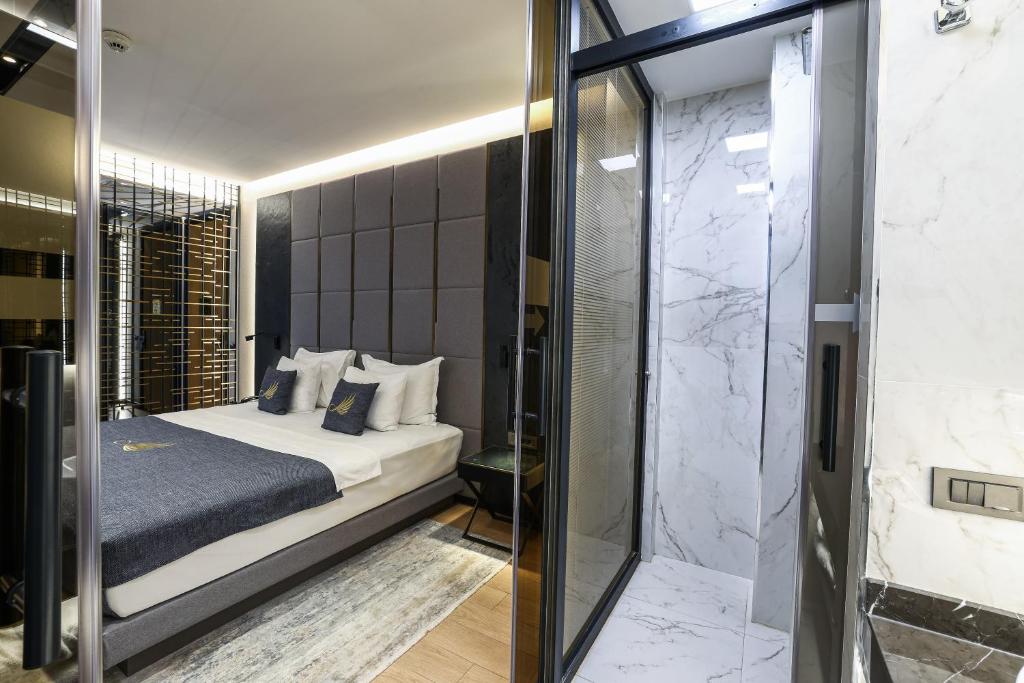 a bedroom with a king sized bed and a shower at Broyt Hotel in Istanbul