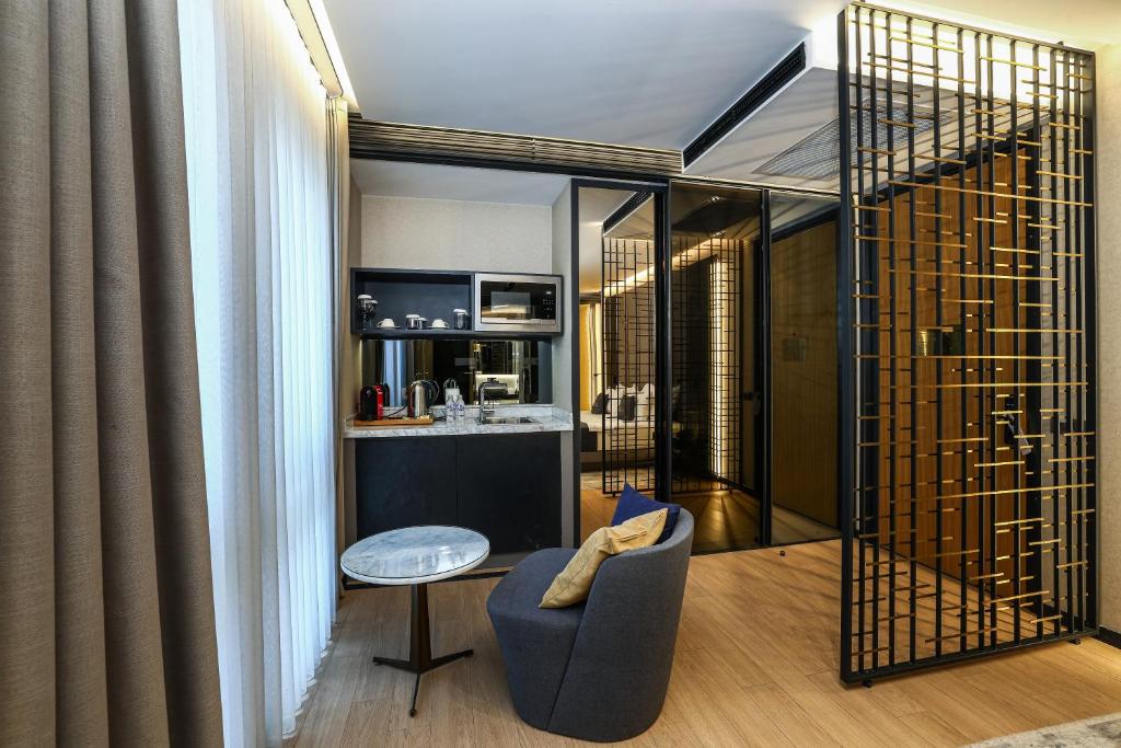 a living room with a couch and a chair at Broyt Hotel in Istanbul