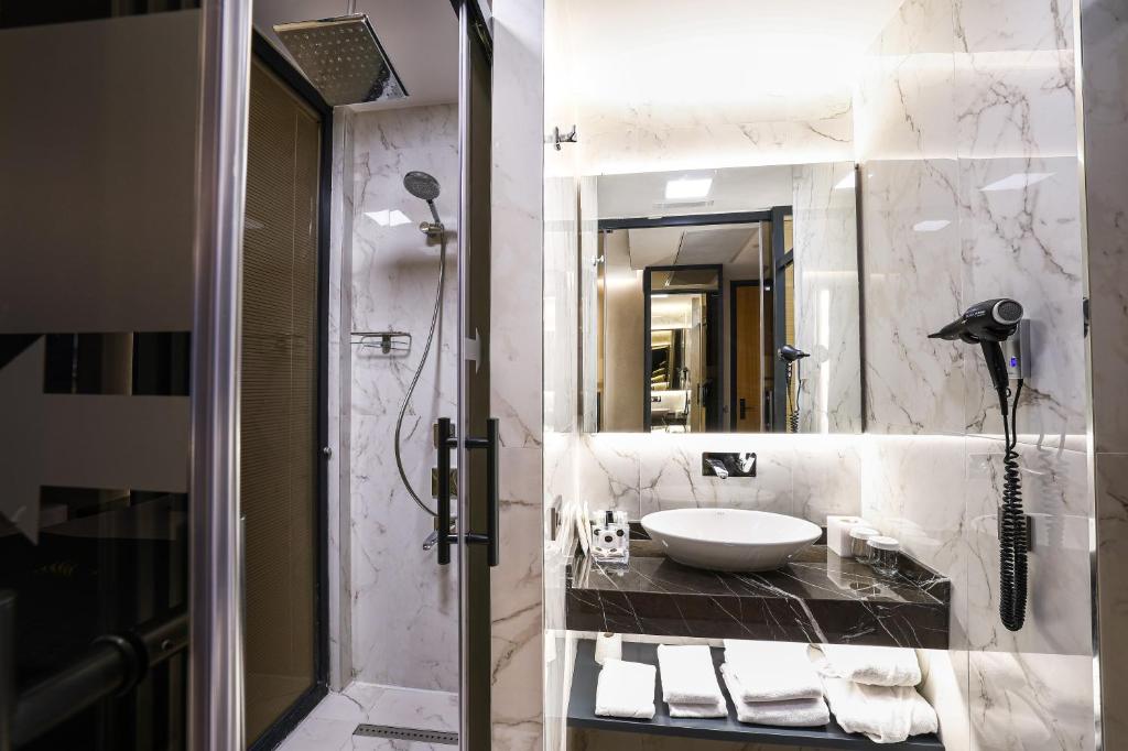 a bathroom with a sink and a shower at Broyt Hotel in Istanbul